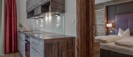 A modern kitchen with wooden cabinets, a built-in oven, and a central island.