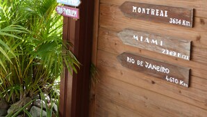 A wooden sign with city names and distances. - Studio in Didier FORT DE FRANCE (Fort de France)
