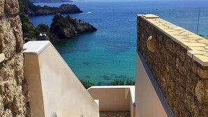 A coastal view with a stone staircase leading to a terrace overlooking the sea. - Platakia Blu (Corfu)