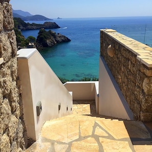 Enjoy breathtaking views of the sea from the spacious terrace with a stone floor and steps leading down to the coast.