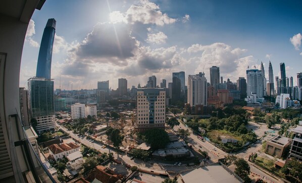 A cityscape with modern high-rise buildings, a mix of commercial and residential structures, and a clear sky.