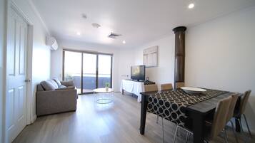 Departamento, 2 habitaciones | Área de sala de estar | Televisión de pantalla plana