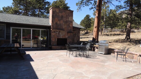 Enjoy al fresco dining and relaxation on the patio, featuring a fireplace, grill, and comfortable seating.