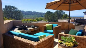 A patio with wicker furniture, a grill, and a view of the landscape. - Ocean & Lagoon View Studio, Walk to Beach, Large Private View Deck  (Del Mar)