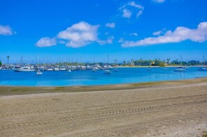 A marina with numerous boats docked along the shoreline.
