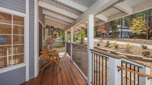 A wooden deck with a railing, a bench, and a view of a landscaped garden with trees and shrubs. - Walk to Summit, Spa, BBQ, Fireplace (Big Bear)