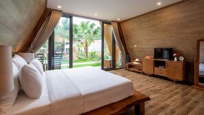 A bedroom with a large bed, wooden flooring, a TV, and a view of the outdoors. - Bai Dinh Garden Resort & Spa Ninh Binh (Tay Hoa Lu)
