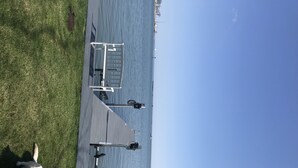A pier extending into a body of water with a clear sky above.