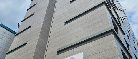 A modern hotel building with a prominent '5-star' logo and a sign indicating it is a '5-star Hotel'.