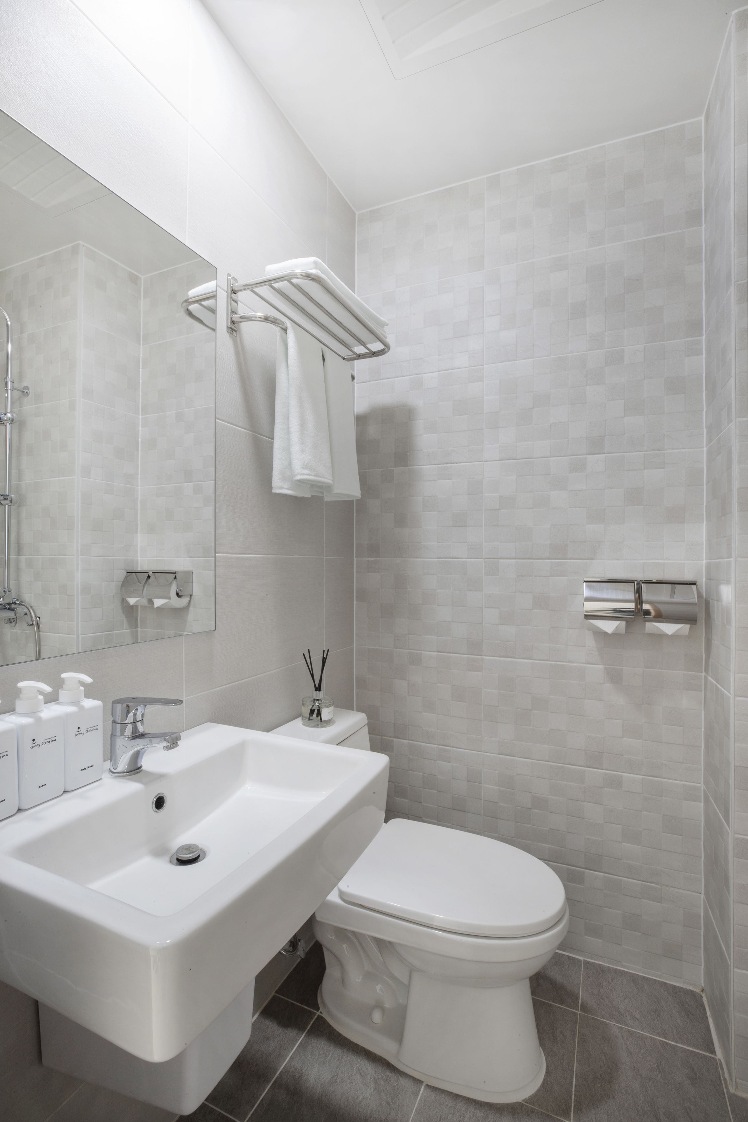 shower, hair dryer, slippers, towels