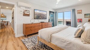 A bedroom with a bed, a dresser, a TV, and a balcony with a view. - Heart of La Jolla Gem - Newly Renovated! (La Jolla)