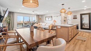 A modern kitchen with wooden cabinetry, a central island, and pendant lighting. - Heart of La Jolla Gem - Newly Renovated! (La Jolla)