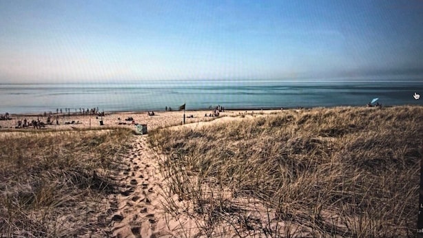 A beach with sand dunes and a clear sky. - Charming Beachfront Home, large backyard and deck, walk over dune to stop2 beach (Michigan City)