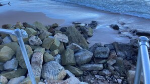 A rocky beach with waves crashing onto the shore. - Cute Lakefront Cottage on Lake Michigan.   (Mears)