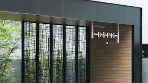 A modern building facade with a vertical wooden panel design and a sign reading "BSPK". - Bespoke Hotel Shinsaibashi (Osaka)