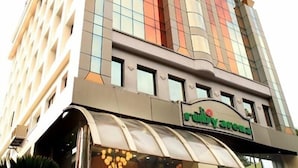 A tall hotel with a modern design, featuring a prominent 'Ruby Arena' sign at the entrance. - Hotel Ruby Arena (Thiruvananthapuram)