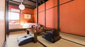 A traditional Japanese room with tatami flooring, a low wooden table, and cushions. - NAKAZ Machiya , Osaka Umeda (Osaka)