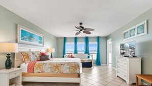 A bedroom with a bed, a nightstand, a dresser, a ceiling fan, and a window with curtains. - Breezeway-Gulf Front Home Sleeps 9 (Navarre)