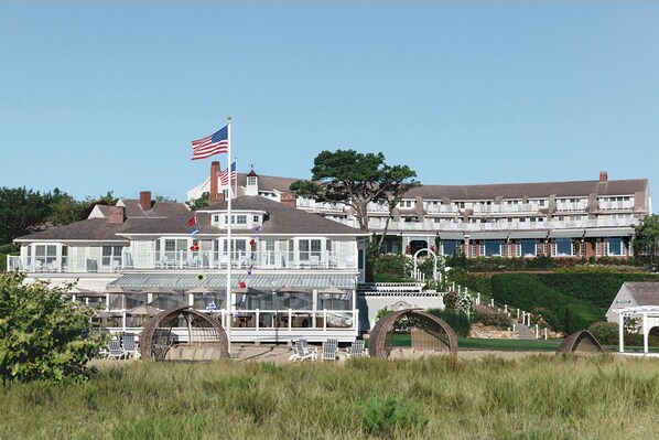 A large, multi-story building with a prominent American flag.