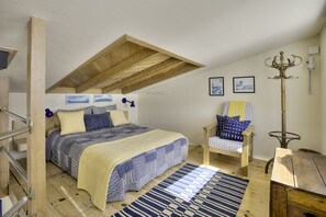A bedroom with a bed, a chair, a coat rack, and a wooden ceiling. - Mermaid's House (Crew Quarters) - Tomales Bay Waterfront, Point Reyes, Marshall (Marshall)