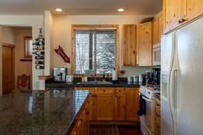Enjoy cooking in this well-equipped kitchen with an oven, sink, and coffee maker.