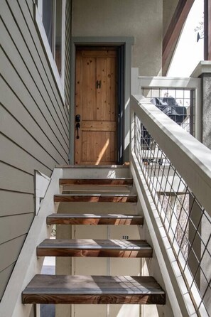 Staircase leads to a building entrance with a door and small window.
