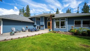 A two-story house with a front porch, a small deck, and a well-maintained lawn. - Hot Tub, Game & Arcade Room, Playground (Hayden)