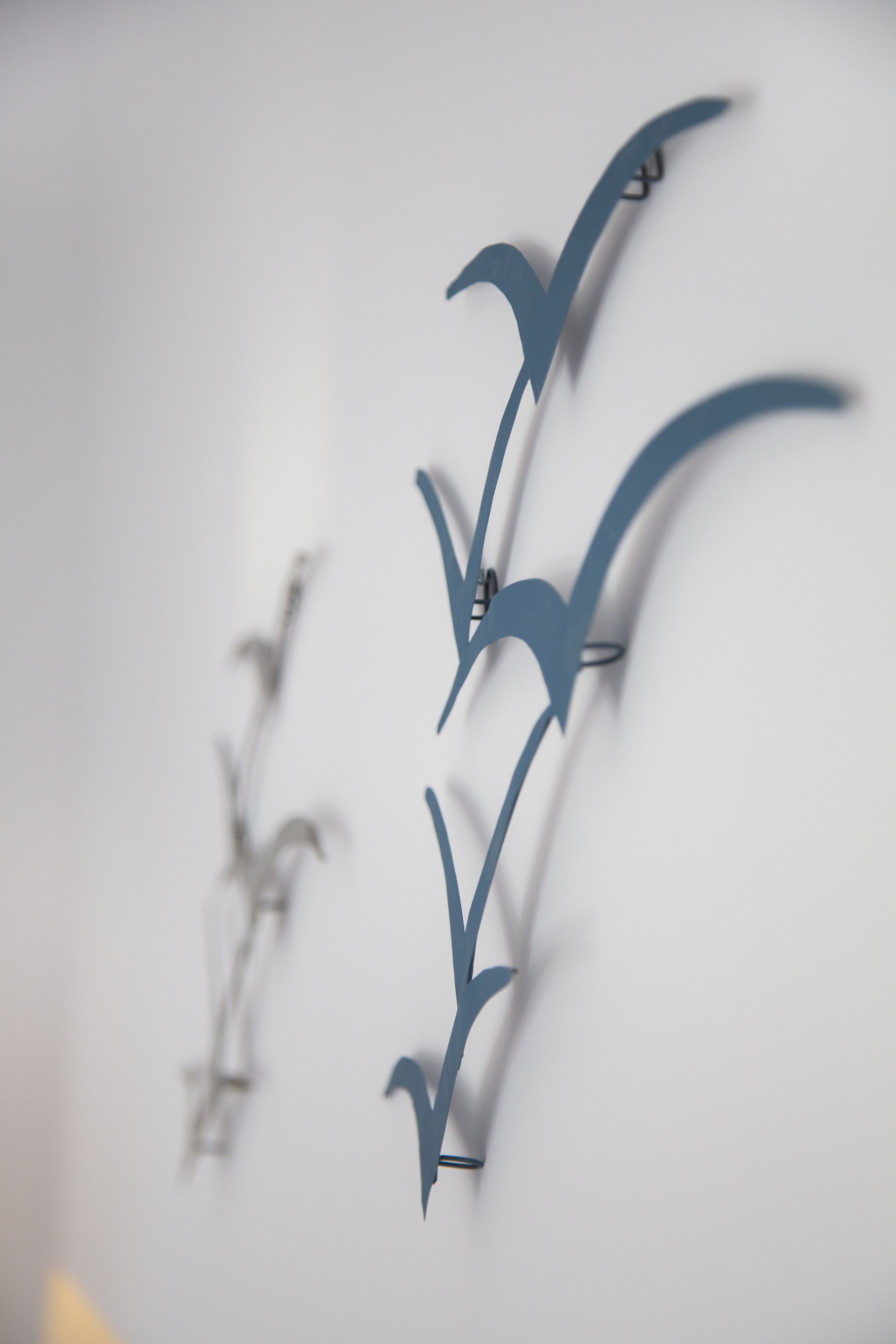 Eine Wand mit drei vogelartigen Aussparungen.