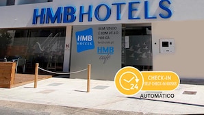 The exterior of HMBHOTELS with a sign indicating 24-hour check-in kiosks. - HMB Fermentelos Hotels (Agueda)