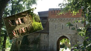 A stone building with an arched entrance, surrounded by greenery and a metal fence. - Schloss Egg (Bernried)