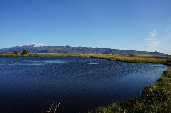 A river with a mountain in the background.