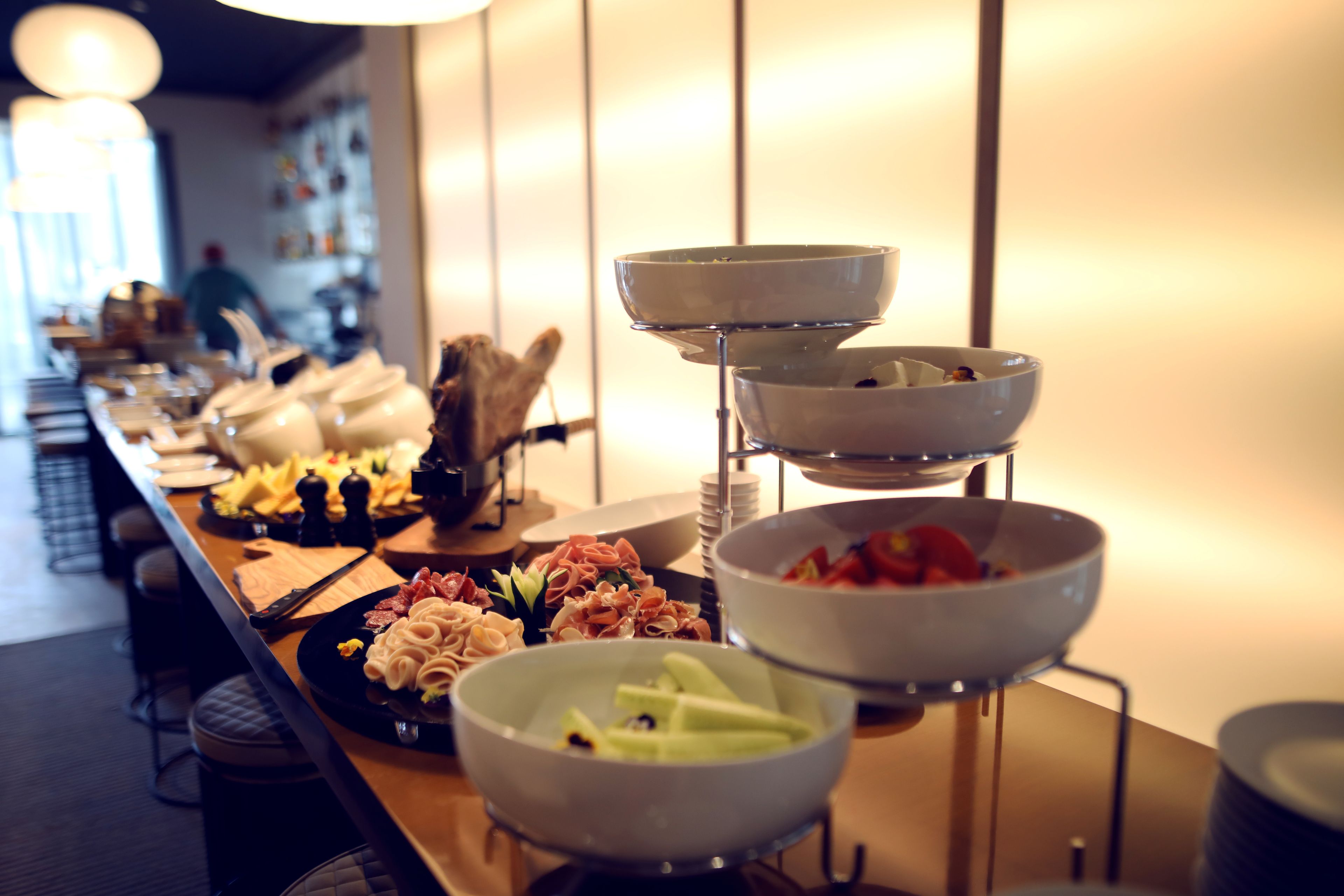 Un buffet proposant une variété de plats, notamment des viandes, des fromages et des légumes.