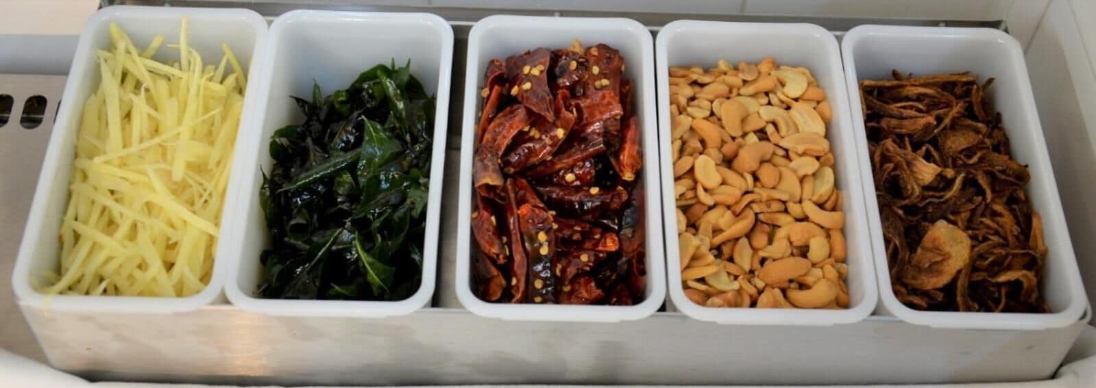 A kitchen with five containers holding different food items.