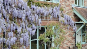 A brick building with a window and a door. - 5 Charlton Mill Way B&B (Chichester)