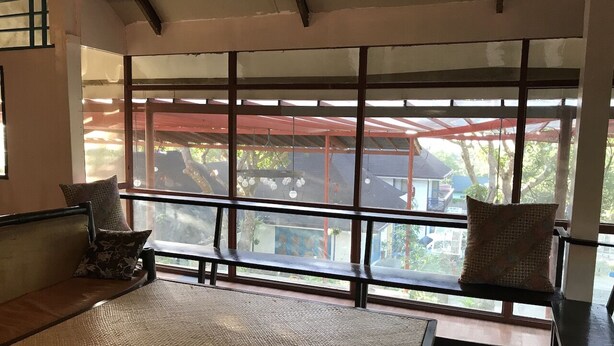 A room with a large window, a sofa, and a bench. - C Donata Bed & Breakfast Guesthouse (Tagaytay)