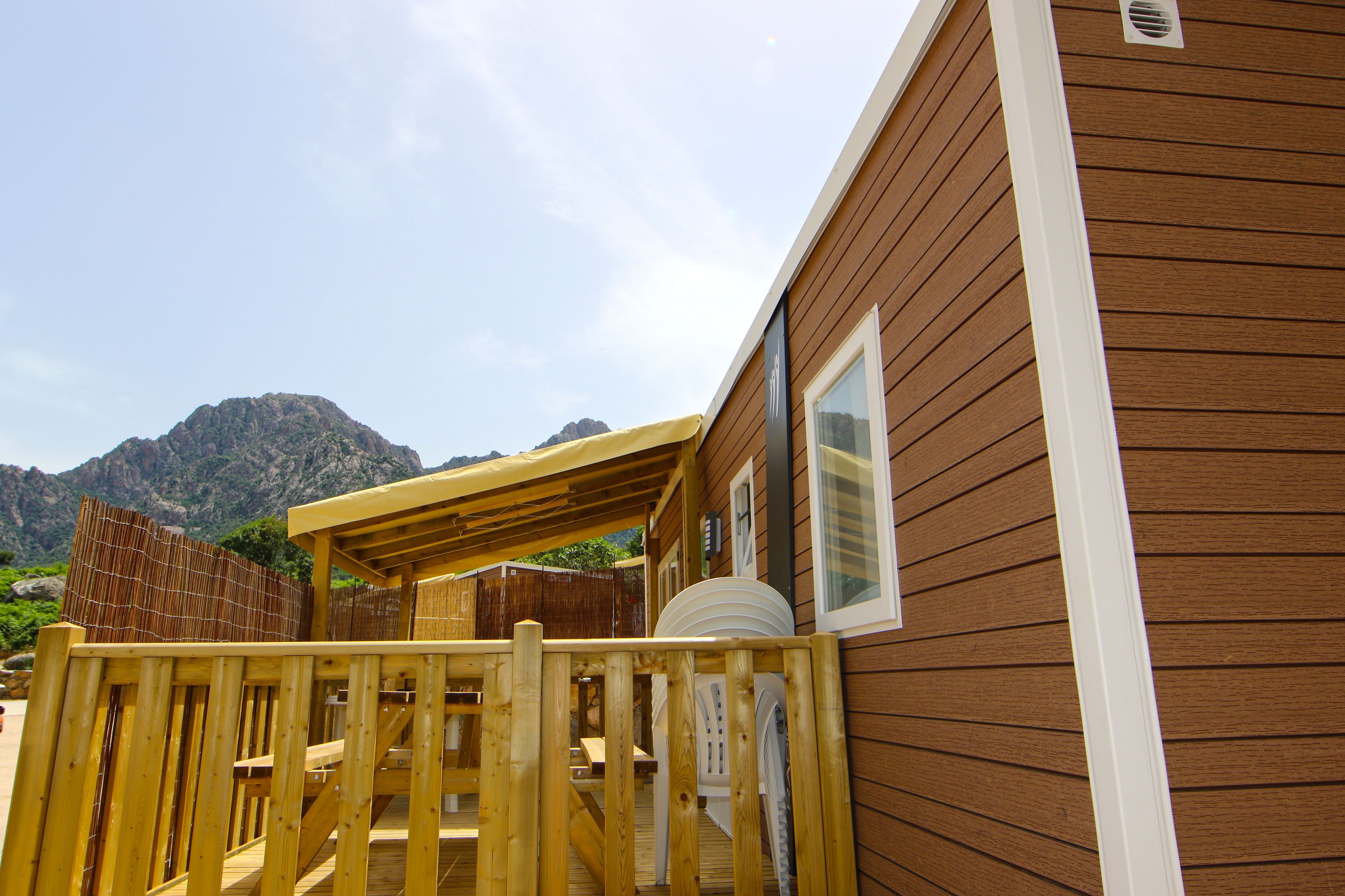 A wooden deck with a view of mountains in the background.