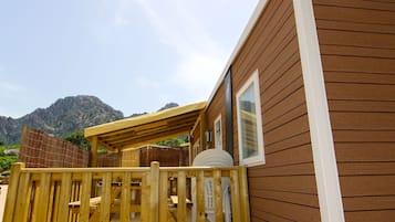 En træterrasse med udsigt til fjelde i baggrunden.