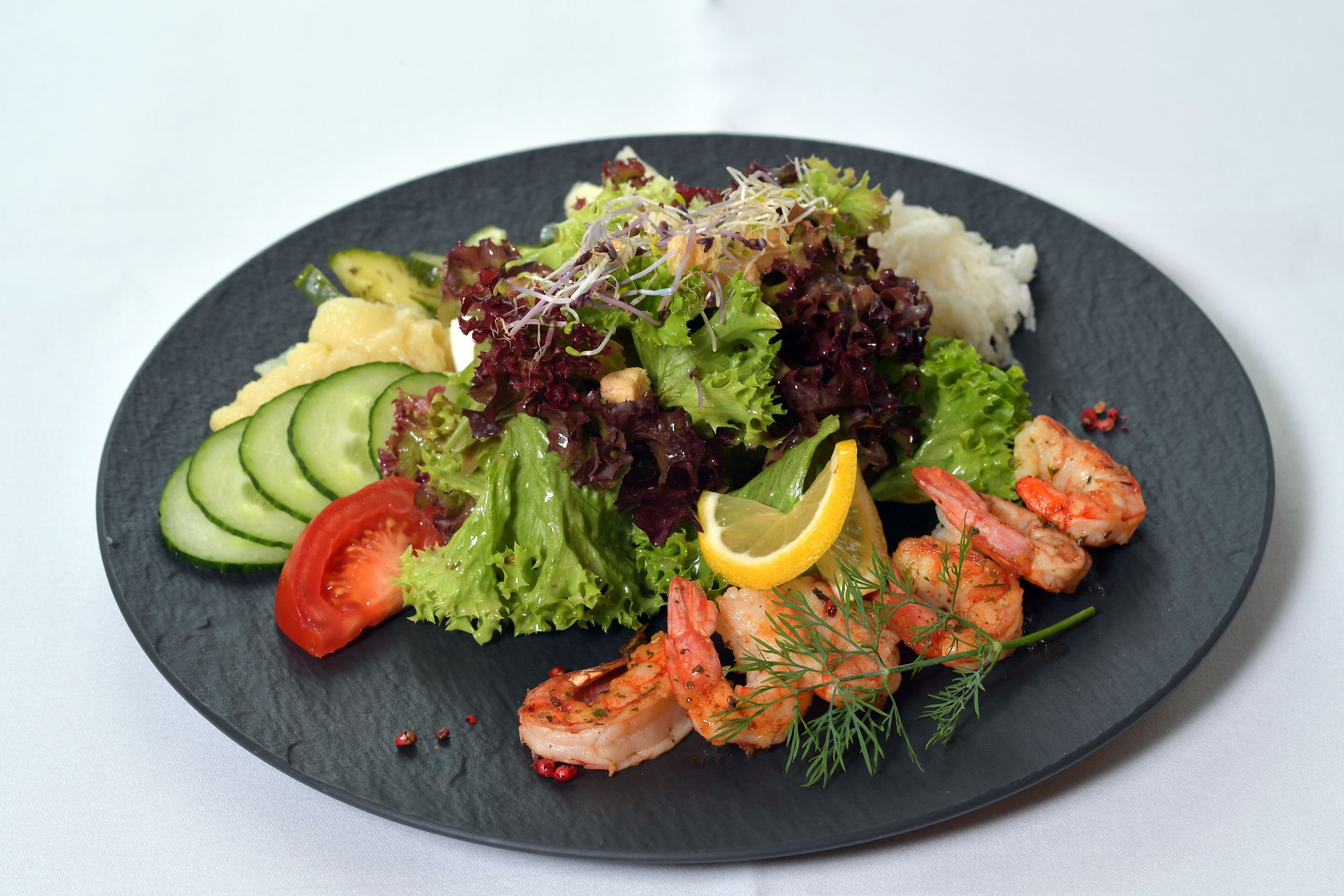 A plate of food with shrimp, vegetables, and rice.