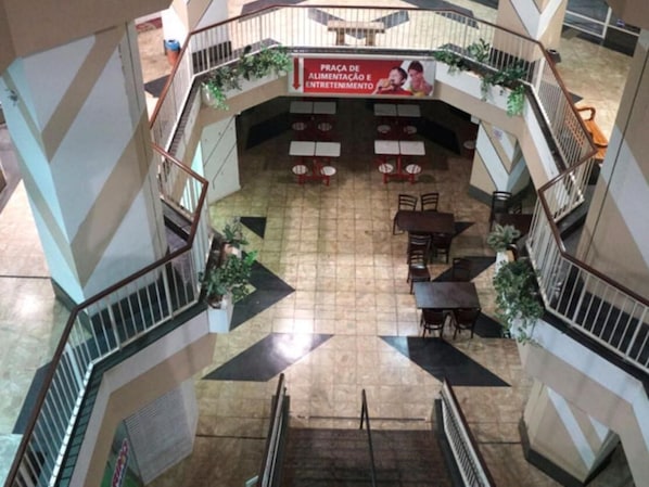 A multi-level atrium with a central open space surrounded by seating areas and staircases.