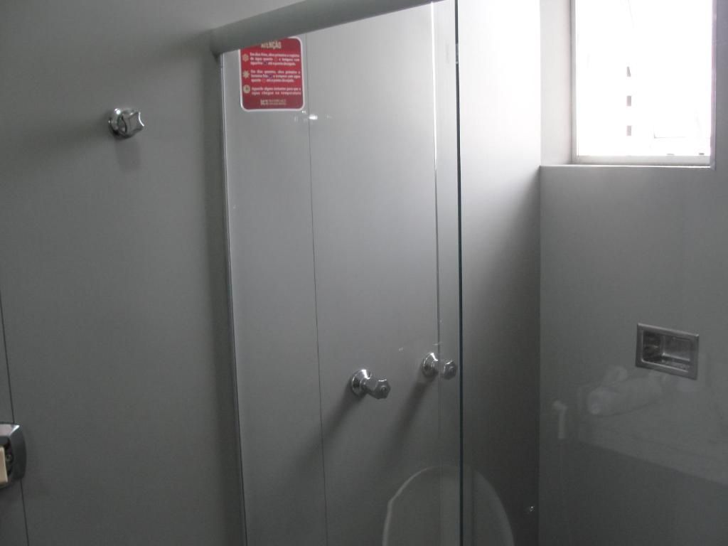 A door with a red sign, a window, and a metal handle.