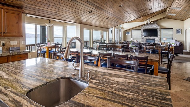 Una cocina amplia con una isla grande, techo de madera y chimenea.
