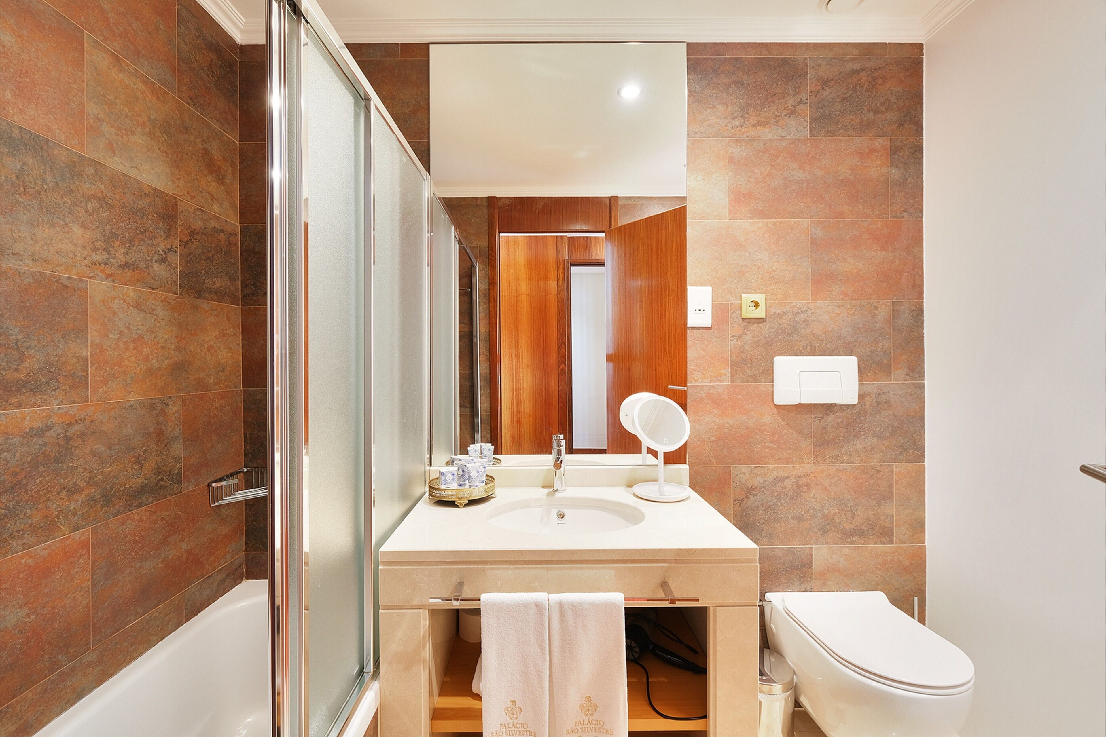 bathtub, hair dryer, towels, soap