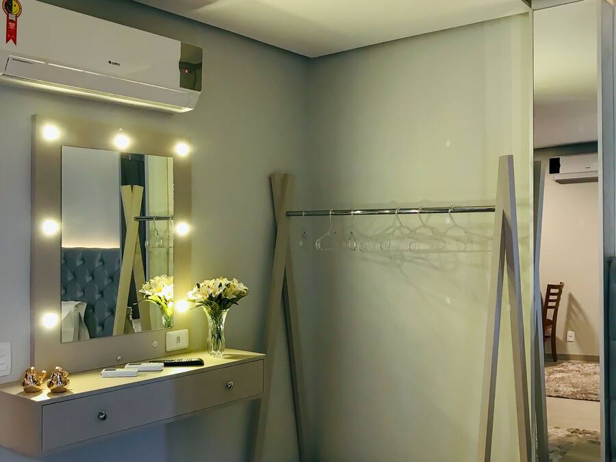 Un baño moderno con tocador, espejo y ducha.