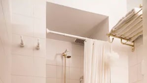 A bathroom with a shower, toilet, and towel rack. - Cerviño y Bulnes 3 (Buenos Aires)