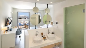 A modern bathroom with two sinks, a mirror, and a green door. - Meltemi Blu - Adults Only (Santorini)