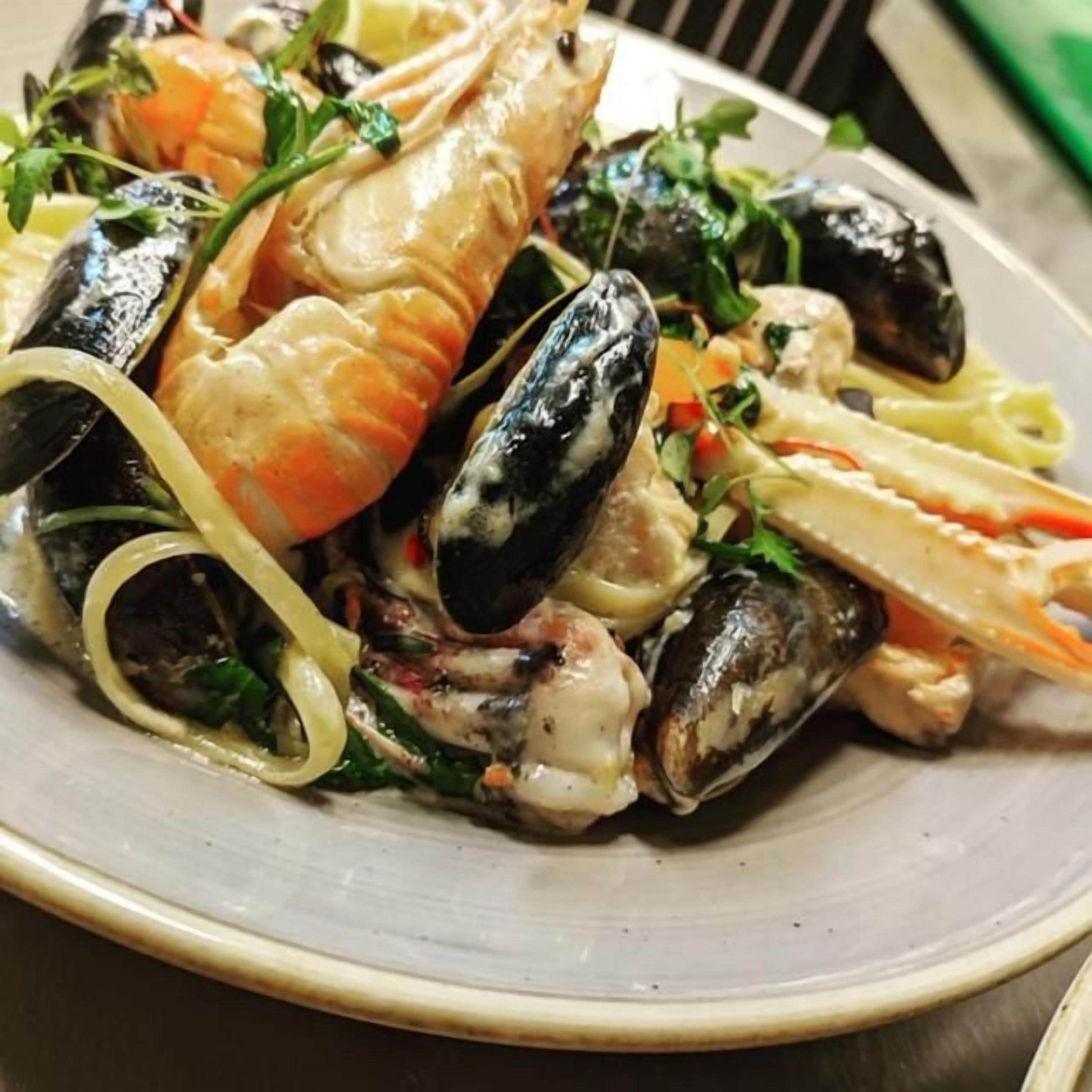 A seafood dish with mussels and shrimp on a plate.