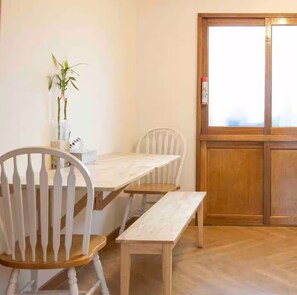 Enjoy meals in this dining area with a wooden table and comfortable chairs.