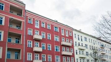 A row of multi-story residential buildings with balconies and windows.