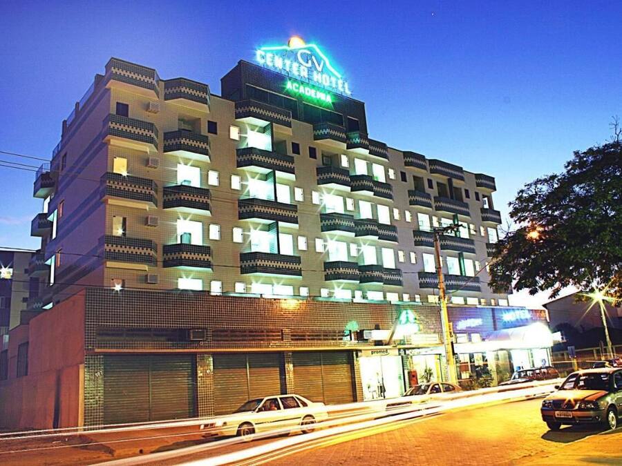 A multi-story hotel with a prominent sign reading "Center Hotel Academia."