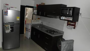 Full-sized fridge, stovetop, rice cooker, cookware/dishes/utensils